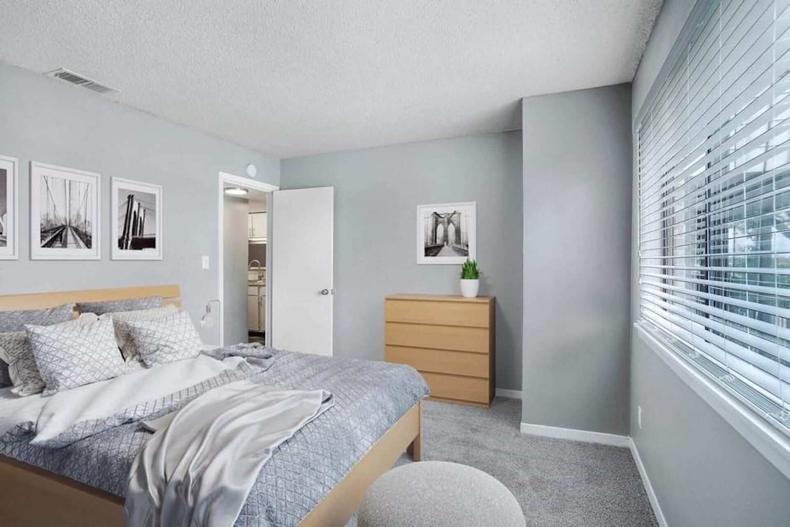 Bedroom with queen size bed and large window