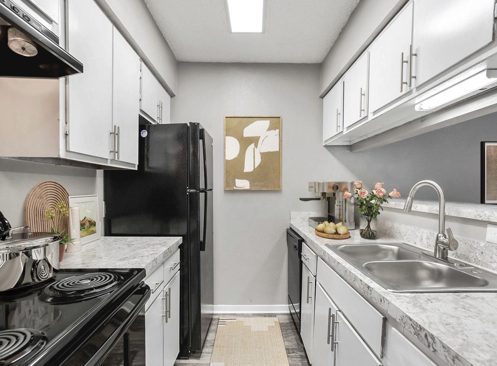 kitchen with gooseneck faucet and black appliances