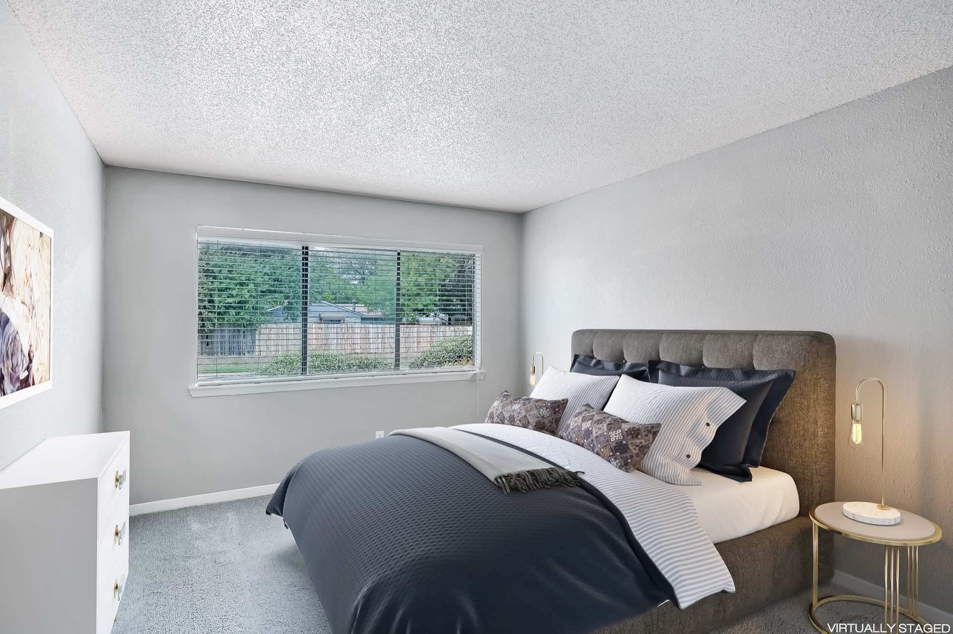 bedroom with plush carpeting and natural lighting
