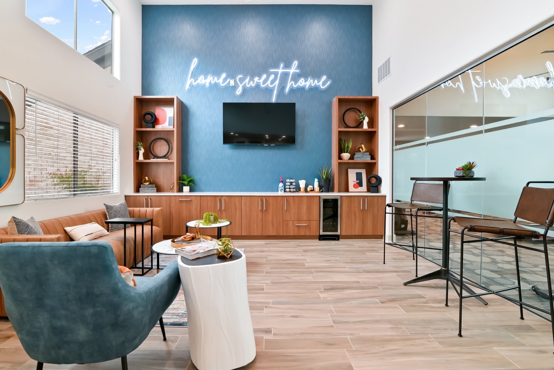 community room with couches, tables and high ceiling